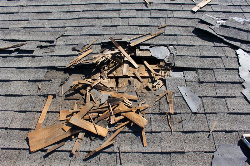 Storm-damaged shingles lifted by strong winds