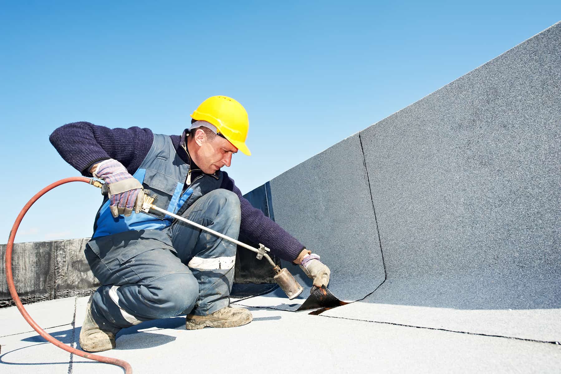Technician working on a flat commercial roof